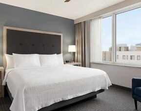 Spacious king suite with work area and TV at Homewood Suites by Hilton University City.