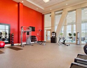Well equipped fitness center with natural light at Homewood Suites by Hilton University City.