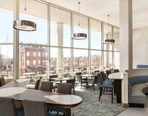 Comfortable lounge and coworking space with lots of natural light at Homewood Suites by Hilton University City.