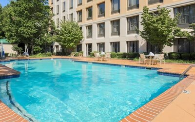 Stunning outdoor pool with seating area at DoubleTree Atlanta Airport.