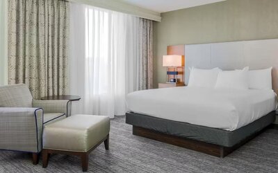 King bed with natural light at DoubleTree Atlanta Airport.