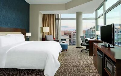 King bed with TV and natural light at Hilton Garden Inn Washington DC / Georgetown Area.