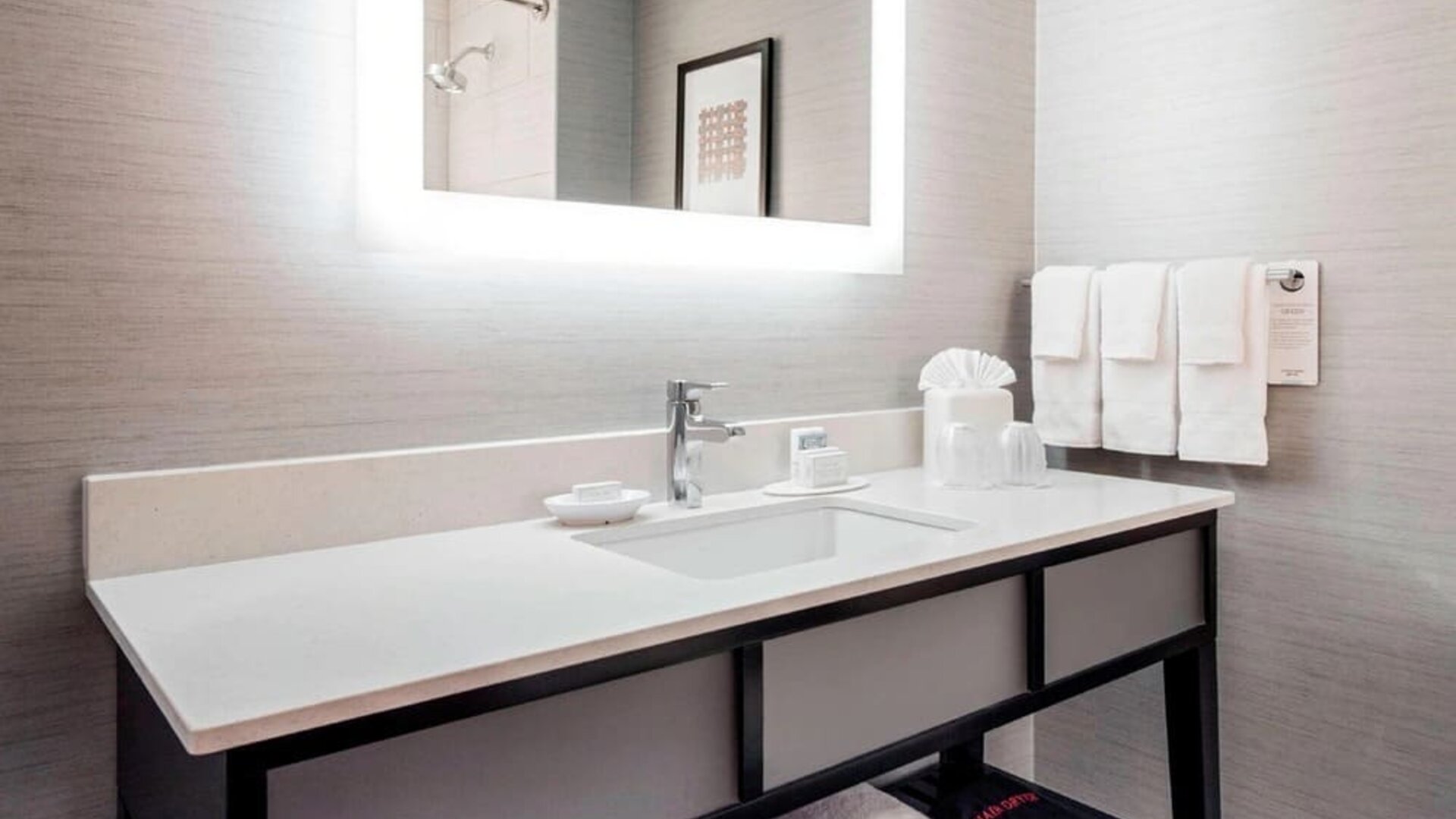 Guest bathroom with shower at Courtyard By Marriott Boston Brookline.