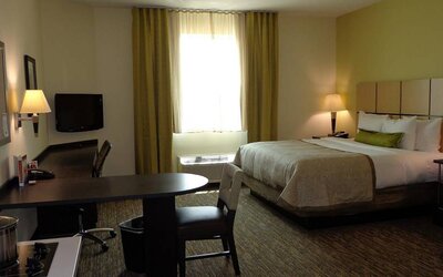 Day use room with work desk and kitchen at Candlewood Suites Odessa.