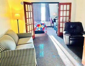 Day use room with living area at Coratel Inn & Suites By Jasper Northfield.