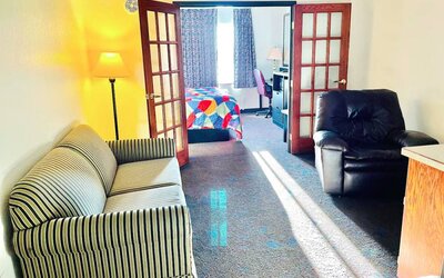 Day use room with living area at Coratel Inn & Suites By Jasper Northfield.