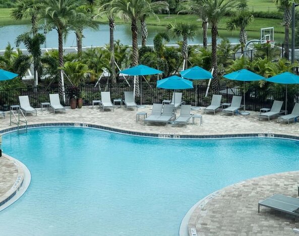 Relaxing pool area with pool chairs at Hampton Inn & Suites Cape Canaveral Cruise Port.