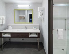 Private guest bathroom with shower at Hampton Inn & Suites Cape Canaveral Cruise Port.