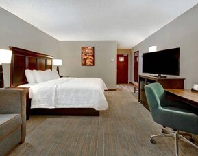 Day use room with work desk and sofa at Hampton Inn & Suites Alexandria.