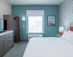 King bed with TV at Home2 Suites By Hilton Cape Canaveral Cruise Port.