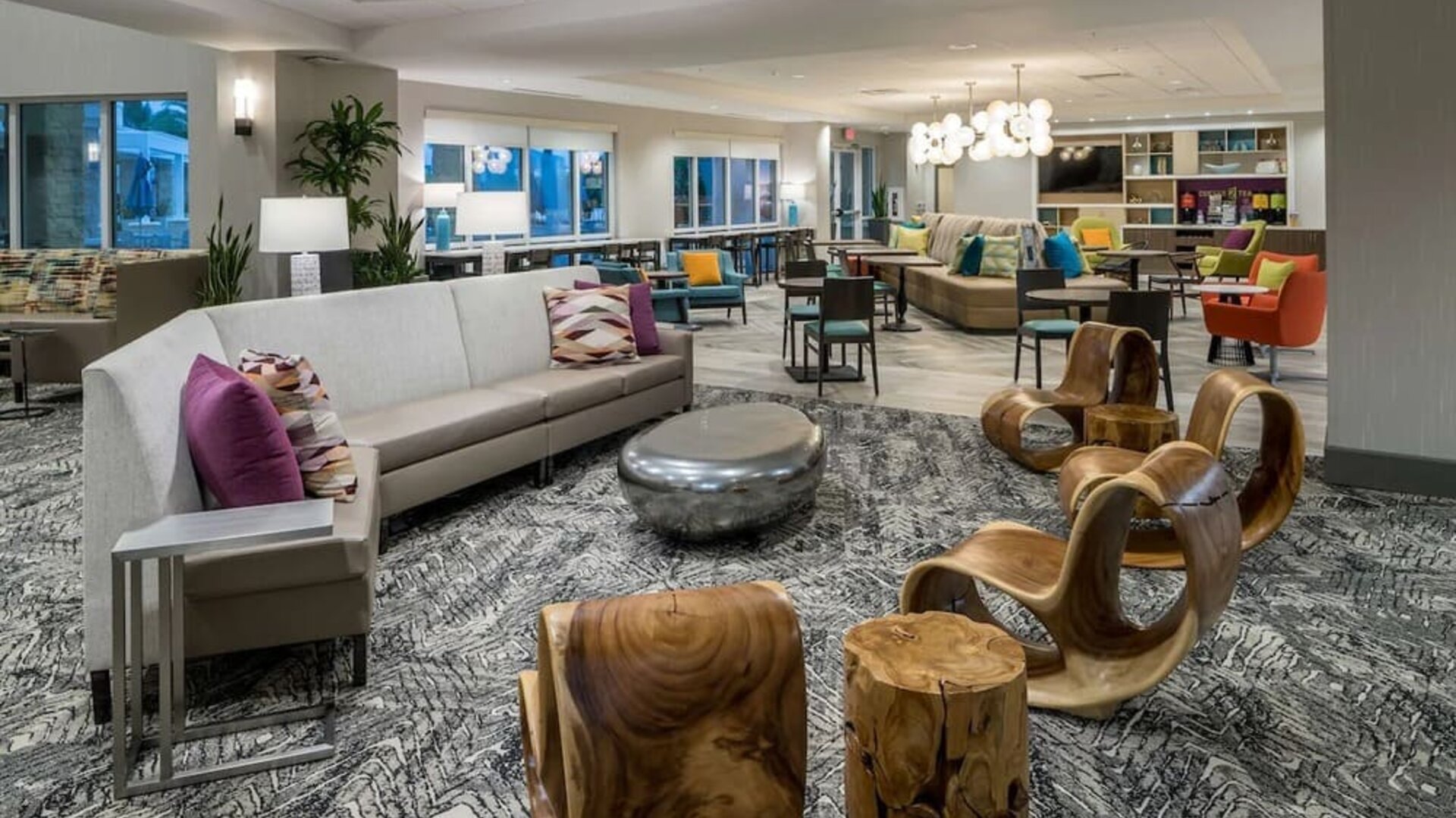 Lobby and coworking space at Home2 Suites By Hilton Cape Canaveral Cruise Port.