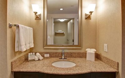 Guest bathroom with shower at Homewood Suites By Hilton Burlington.