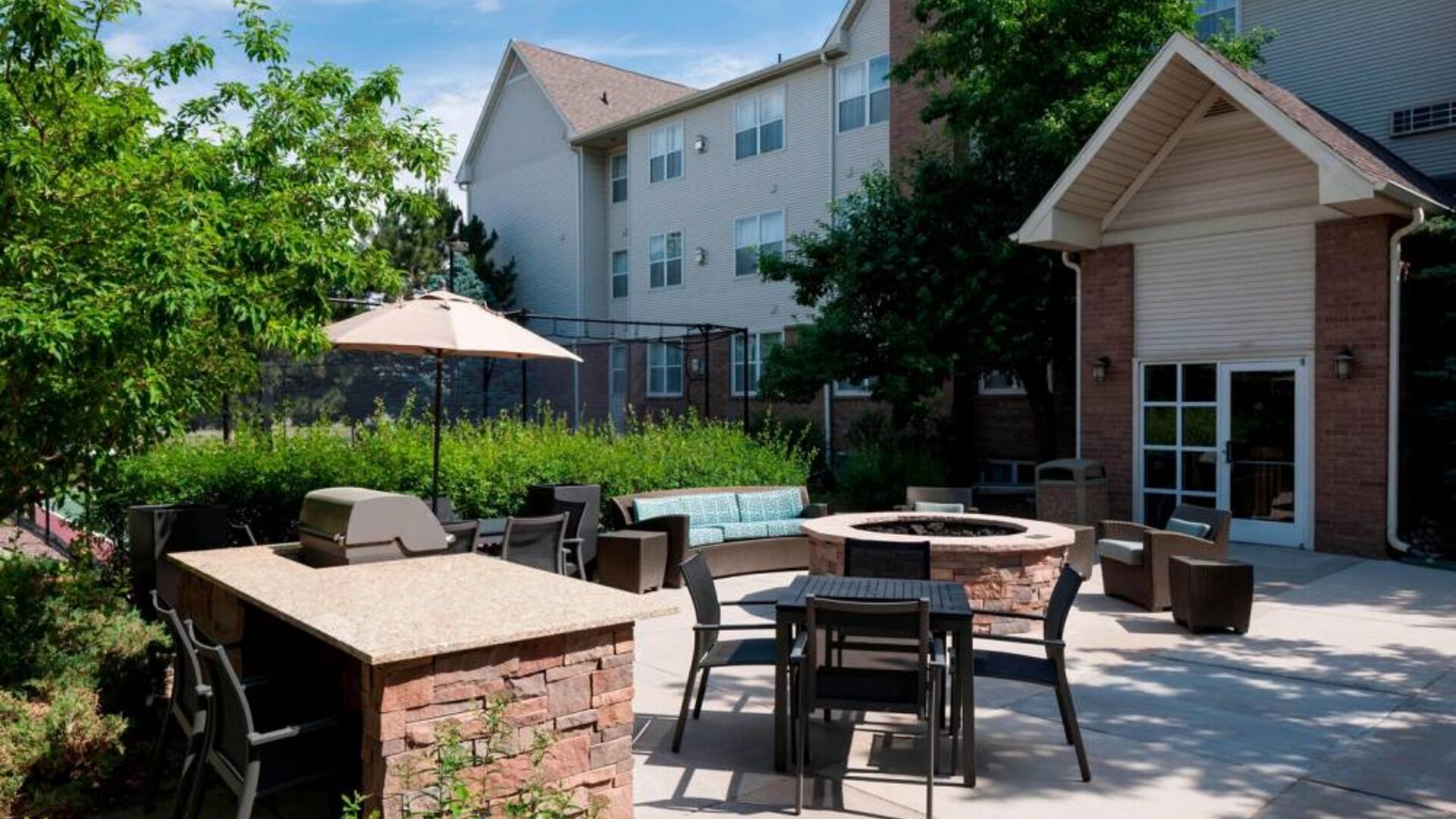 Fire pit and BBQ grill area at Residence Inn By Marriott Denver Highlands Ranch.
