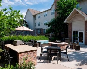 Fire pit and BBQ grill area at Residence Inn By Marriott Denver Highlands Ranch.