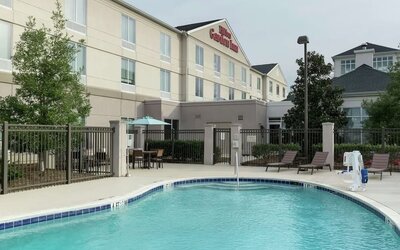 Stunning outdoor pool with pool chairs at Hilton Garden Inn Dothan.
