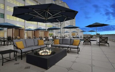 Relaxing outdoor terrace with fire pits at Hilton Baton Rouge Capitol Center.