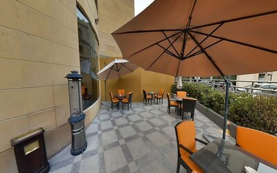 Outdoor terrace and coworking space at Millennium Central Doha.