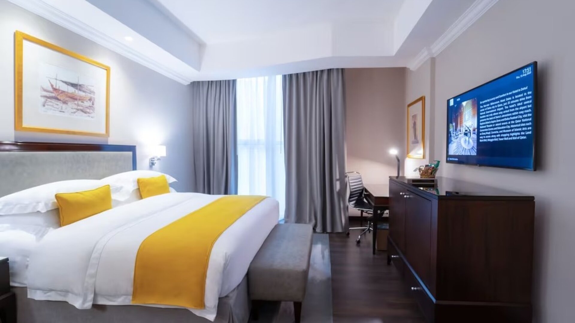 King bed with TV at Millennium Hotel Doha.