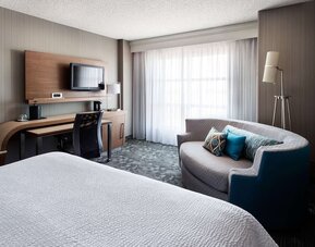 Delux king bed with TV at Sonesta Emeryville - San Francisco Bay Bridge.