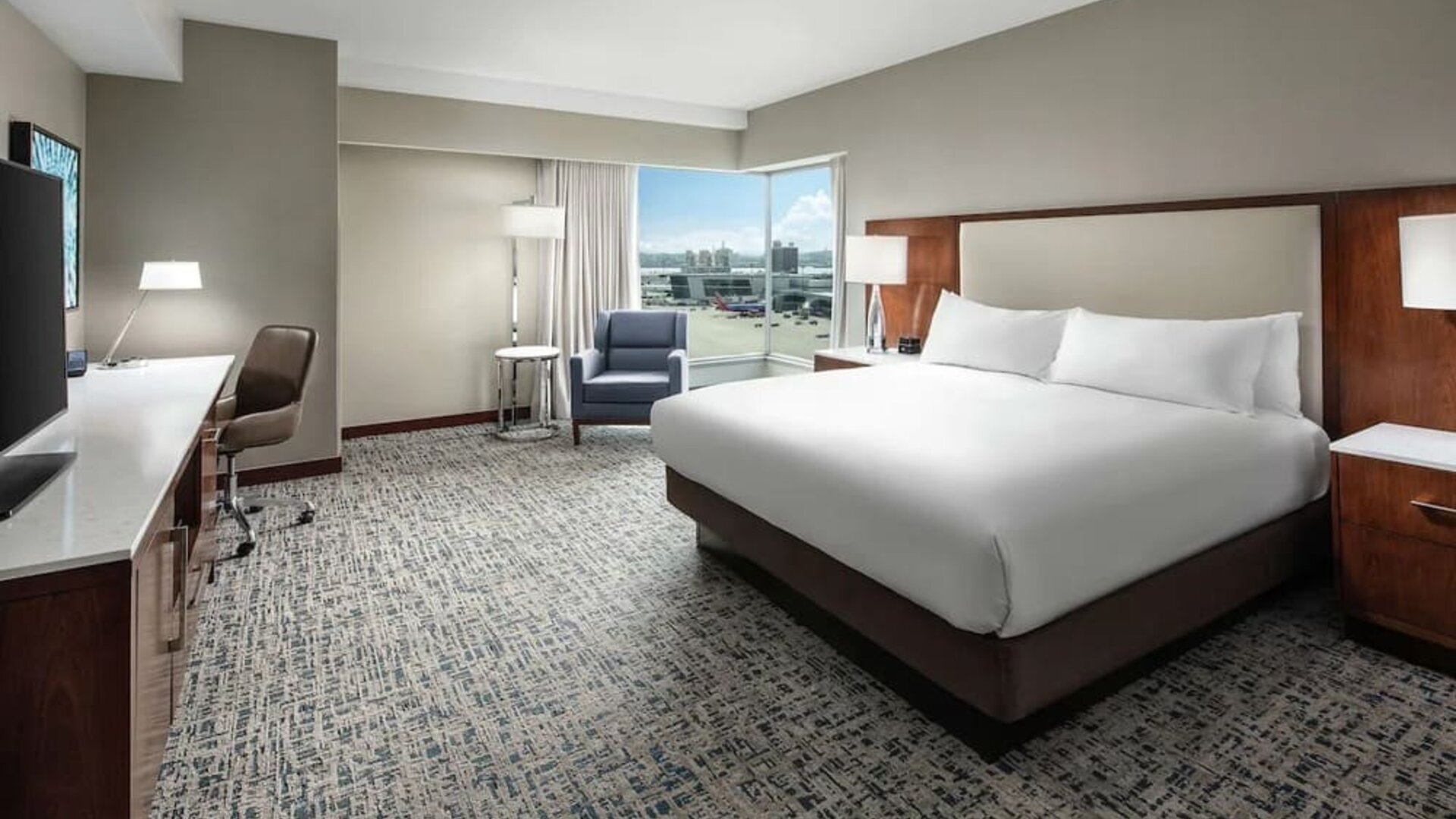 Delux king room with natural light at Hilton Boston Logan Airport.