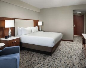 King bed with TV and work desk at Hilton Boston Logan Airport.