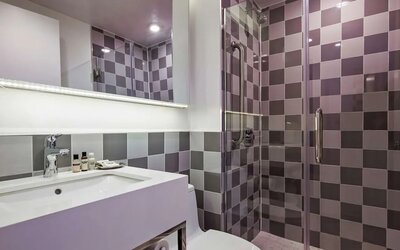 Guest bathroom with shower at Best Western Premier Empire State Hotel.