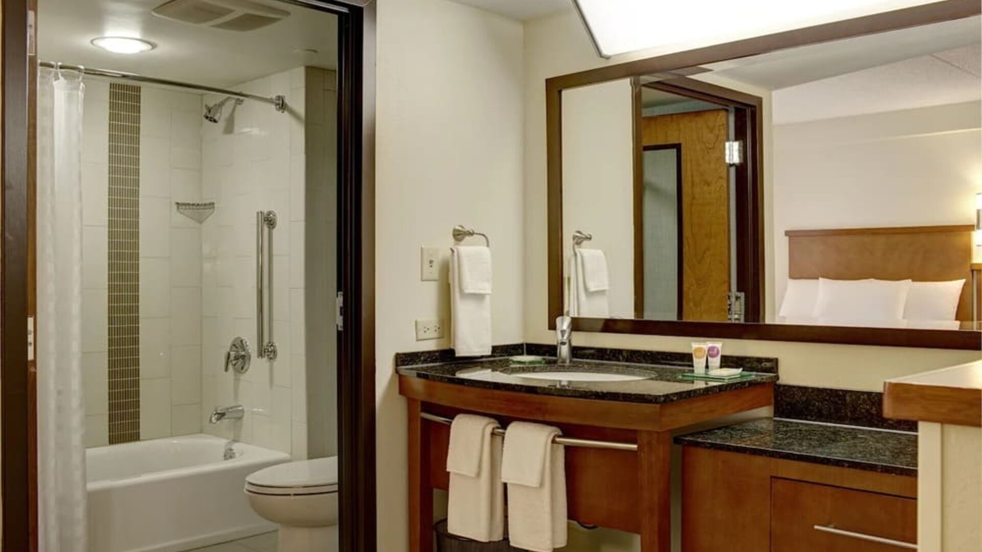 Guest bathroom with shower and tub at Hyatt Place Fort Lauderdale Cruise Port.