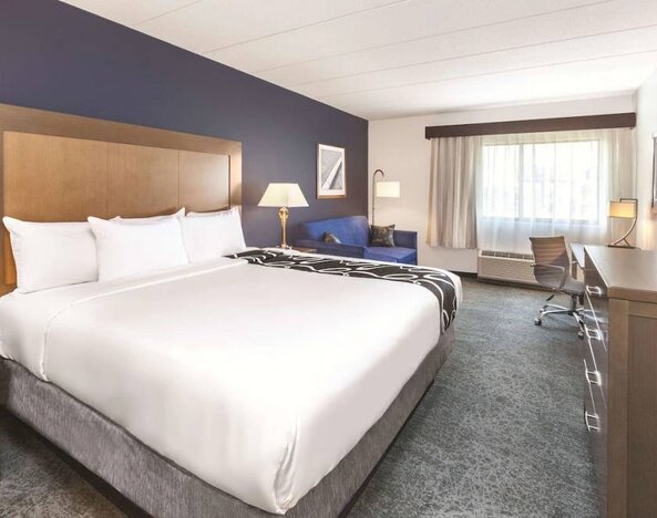 Day use room with work desk and sofa at La Quinta Inn & Suites By Wyndham Philadelphia Airport.
