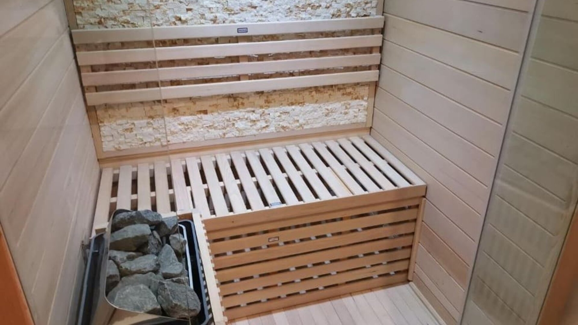 Private in-room sauna with wooden seating, stone heater, and relaxing wellness amenities at Hotel Chao 24/7.
