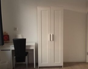 Guest room workspace with desk, chair, wardrobe, and modern amenities at Hotel Chao 24/7.