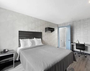 Day use room with work desk and natural light at Hotel 365 Bronx.