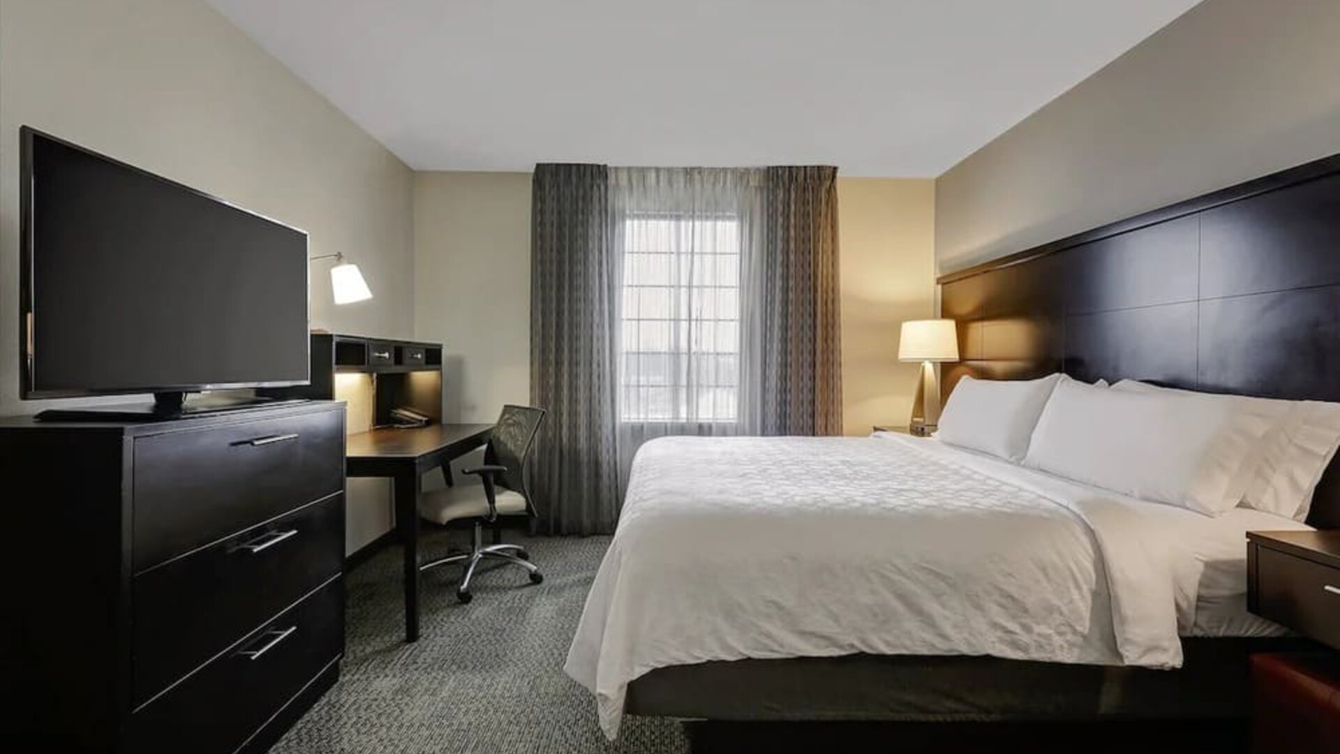 King bed with TV at Staybridge Suites Washington D.C.- Greenbelt.