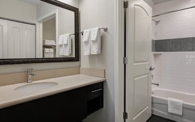 Private guest bathroom with shower and bath combo at Staybridge Suites Washington D.C.- Greenbelt.
