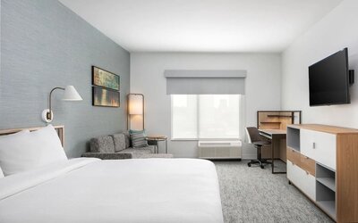 Bright-lit day use room with work desk and sofa at TownePlace Suites Nashville Midtown.