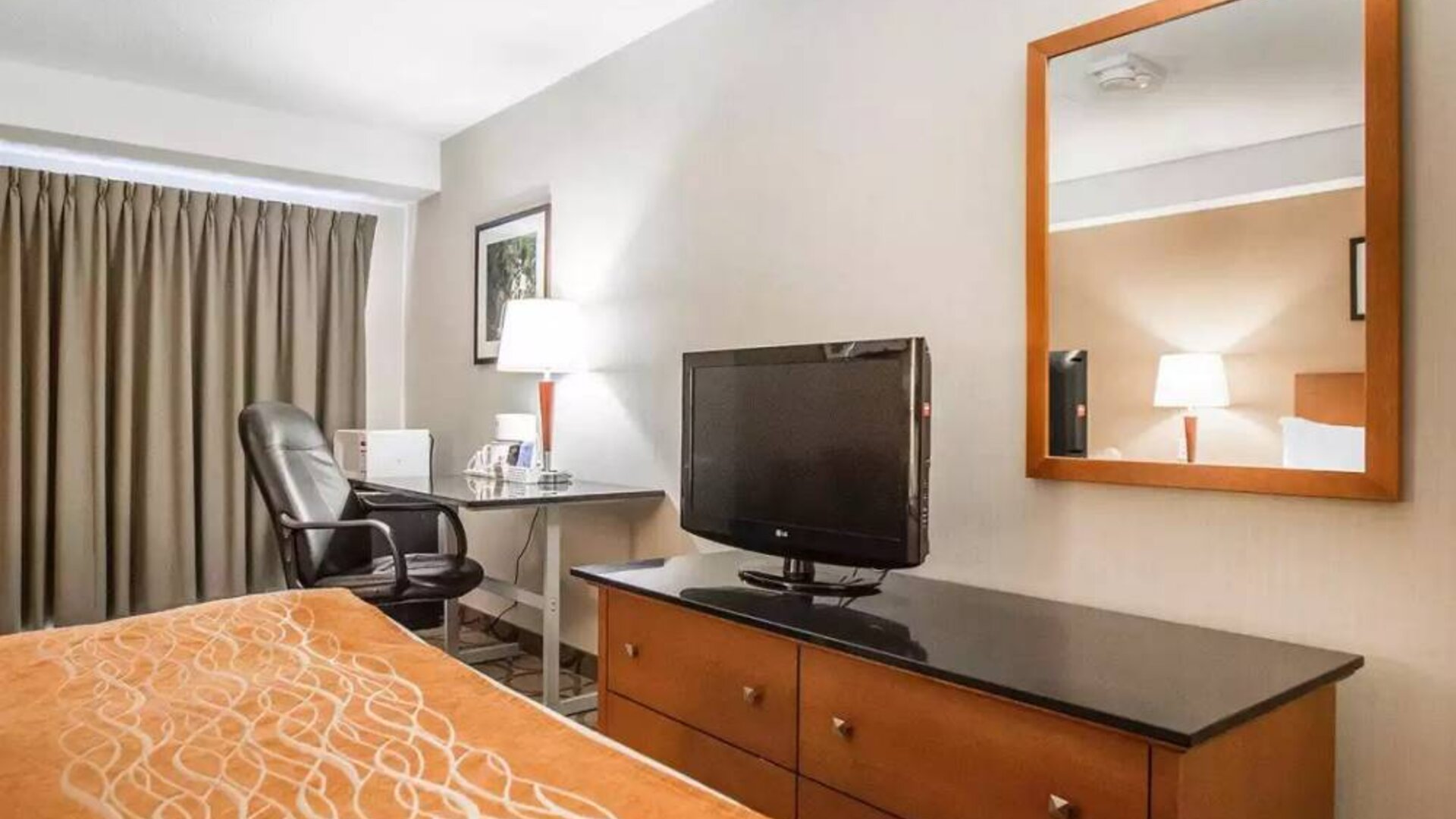 Guest room in Comfort Inn Truro, including double bed, and workspace desk and chair.