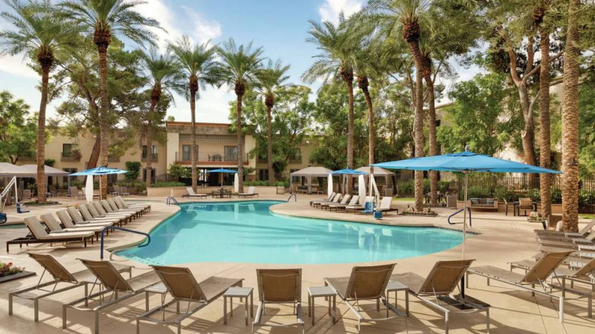 Stunning outdoor pool with sun beds at Hilton Scottsdale Resort & Villas.