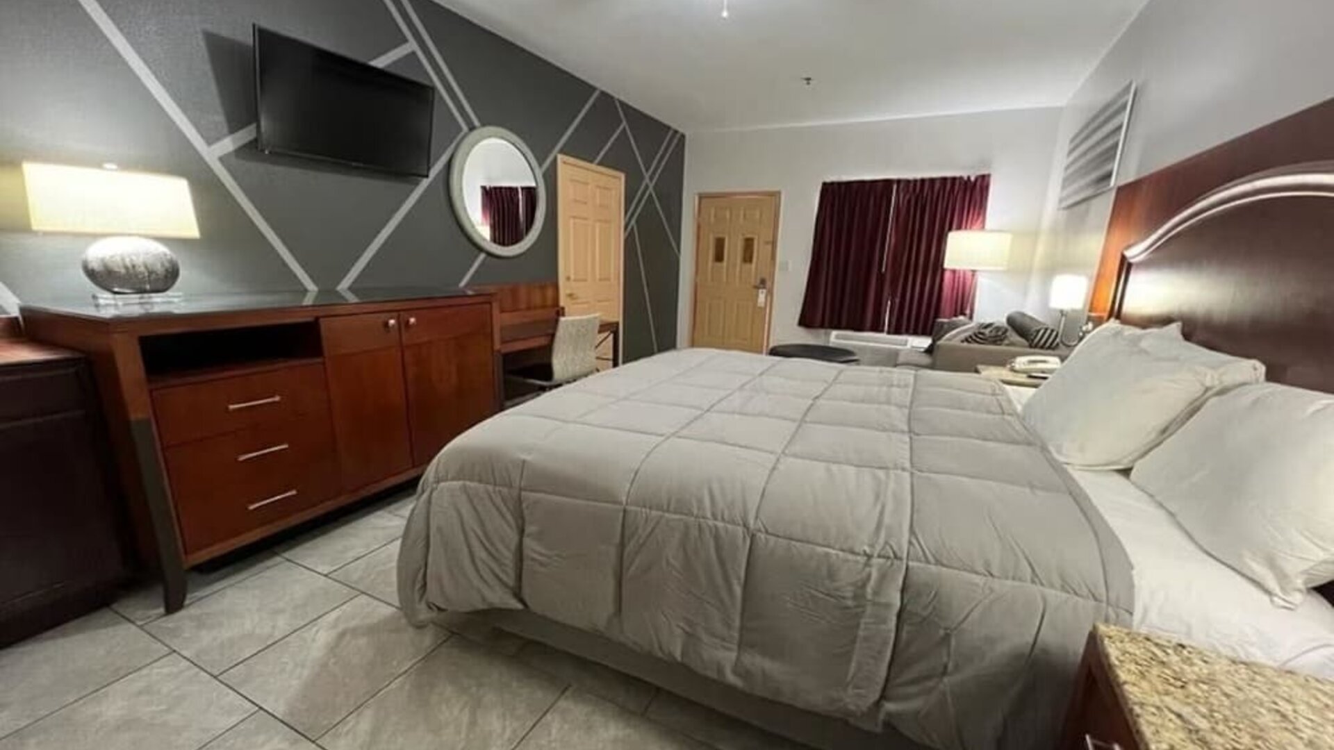 King bed with TV at Casa Rosa Inn.