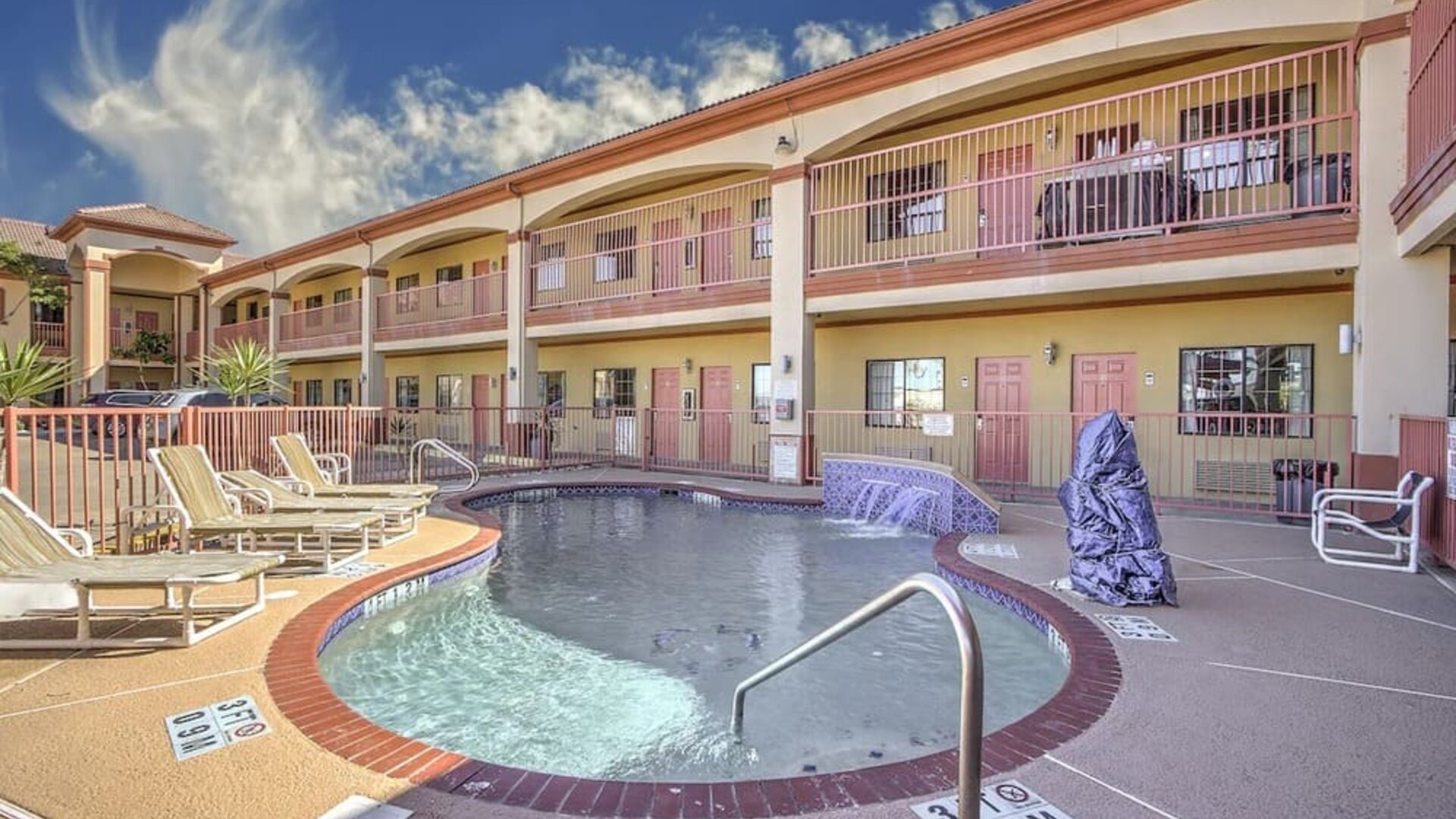 Relaxing pool area with loungers at Casa Rosa Inn.