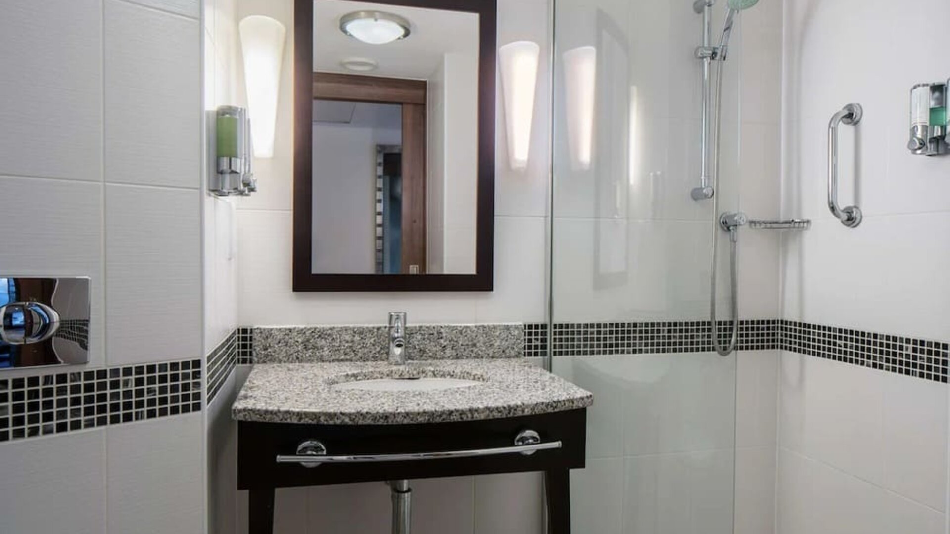 Guest bathroom with shower at Hampton By Hilton Birmingham Broad Street.