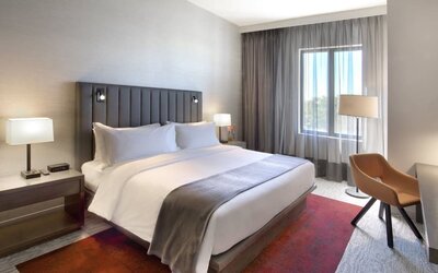 Delux king bed with TV and business desk at Fairfield Inn & Suites By Marriott Kenosha Pleasant Prairie.