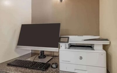 Hotel business center workstation, including monitor, keyboard, mouse, and printer.