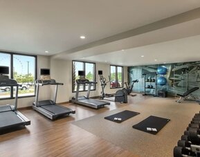 Fully equipped fitness center at Embassy Suites By Hilton Panama City Beach Resort.