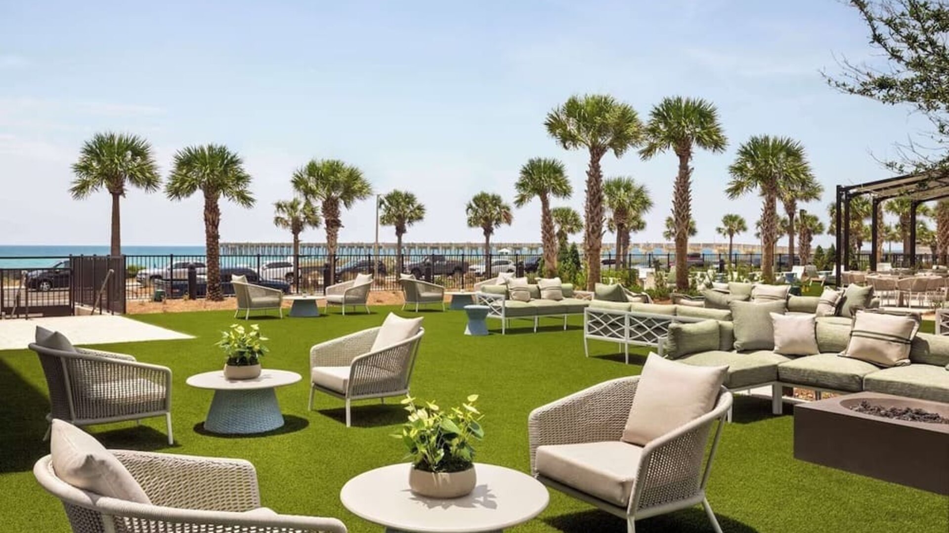 Terrace with sea view and lounge seating at Embassy Suites By Hilton Panama City Beach Resort.