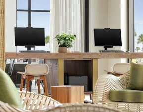Business center with computers and printer at Embassy Suites By Hilton Panama City Beach Resort.