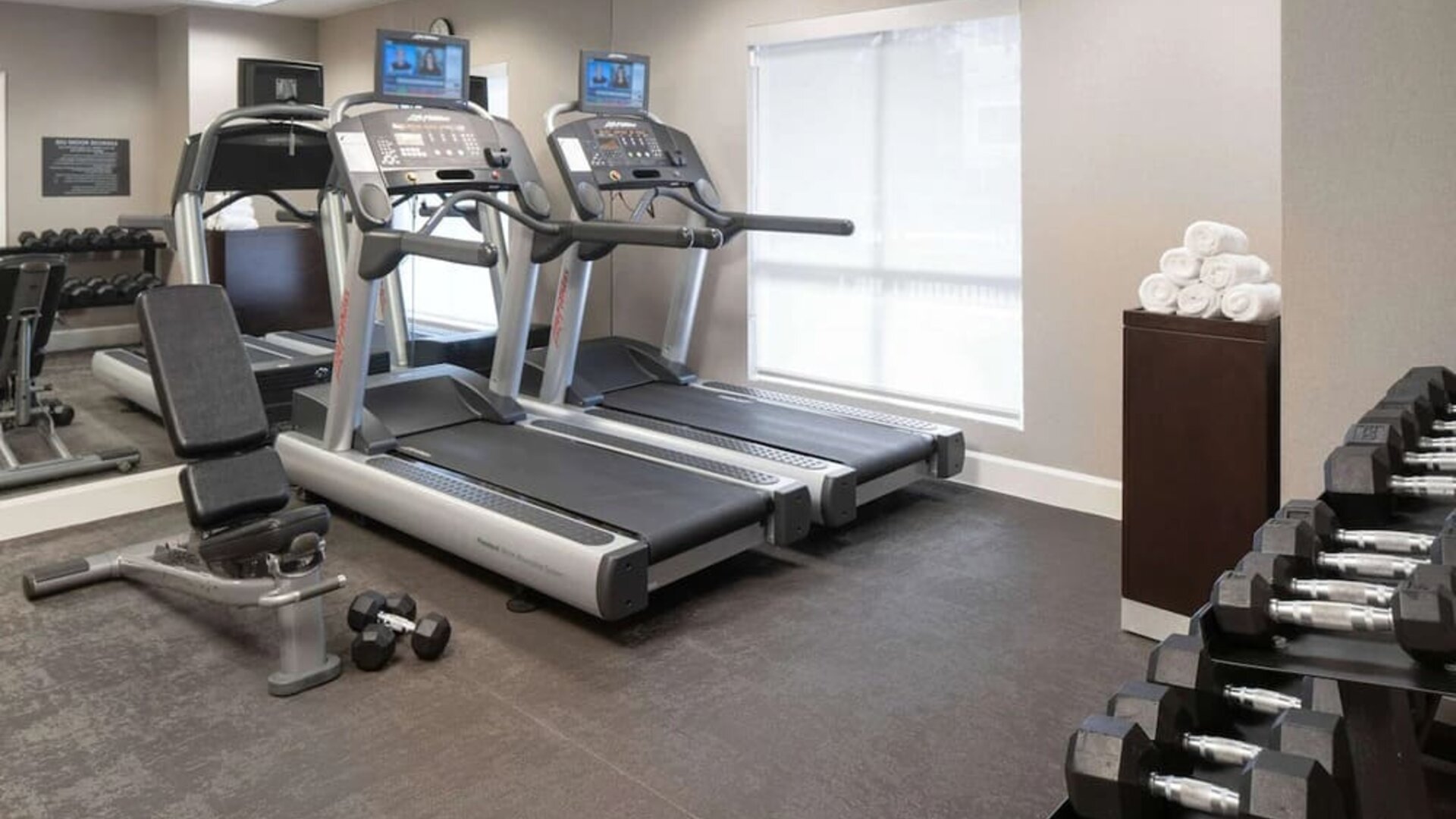 The hotel fitness center is equipped with racks of free weights plus treadmills.