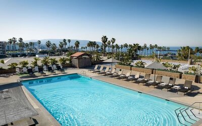 Stunning outdoor pool area with pool chairs at Sonesta Redondo Beach & Marina.