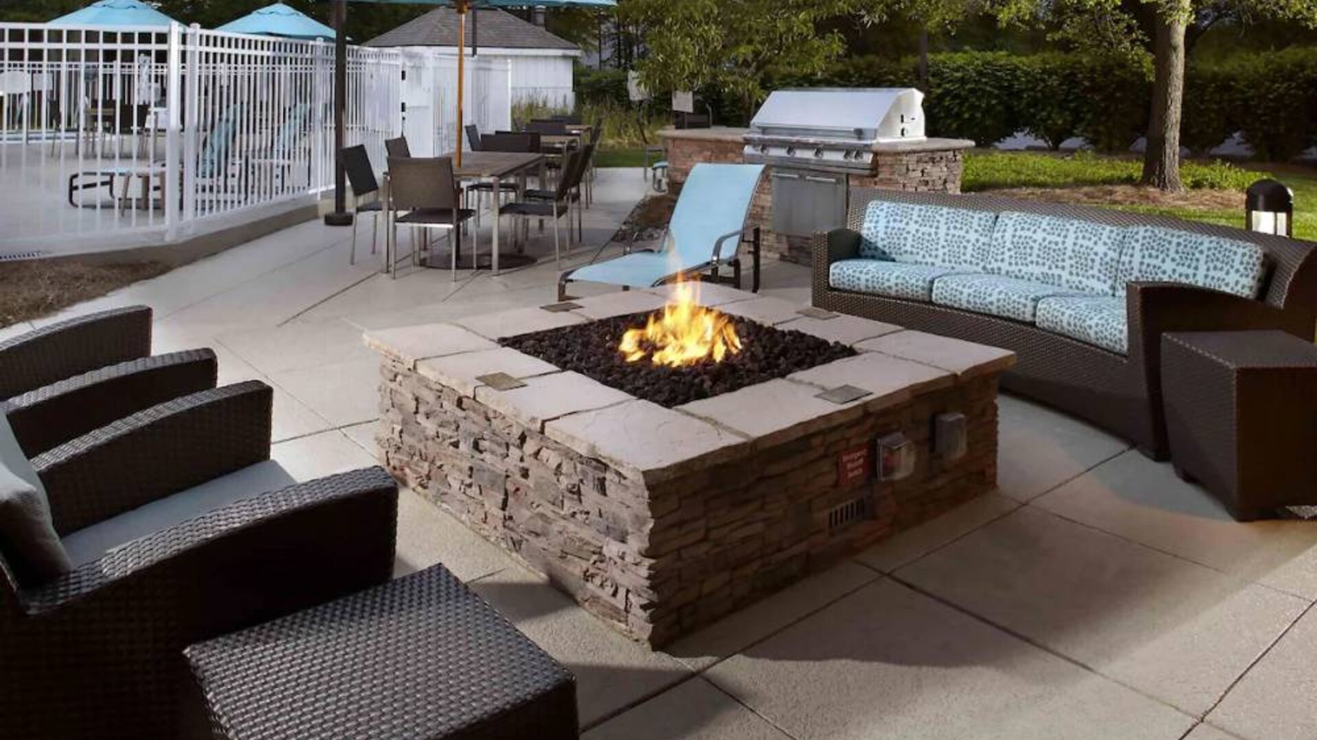 Sonesta ES Suites Cincinnati - Blue Ash’s patio area features a fire pit, plus tables and chairs, and a barbecue.