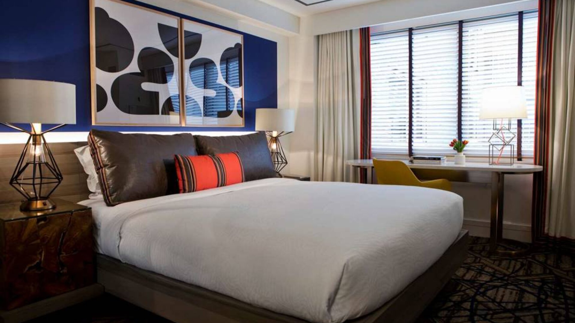 Royal Sonesta Washington DC Dupont Circle double bed guest room, featuring a window, and a workspace desk, chair, and lamp.