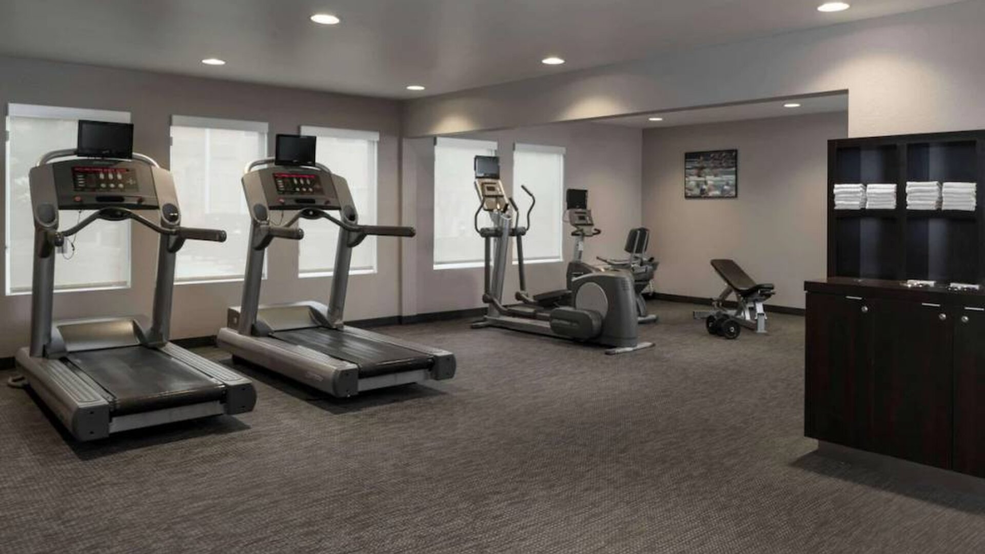 The hotel fitness center has an assortment of exercise machines and free weights.