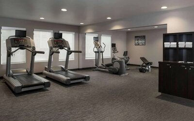 The hotel fitness center has an assortment of exercise machines and free weights.